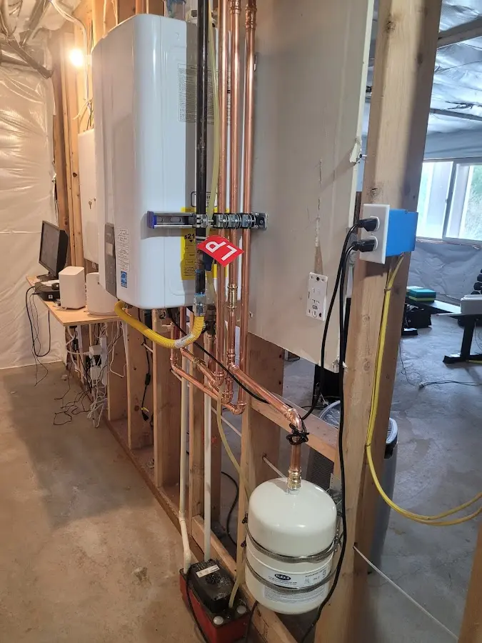 Licensed plumber repairing a kitchen sink in Athol